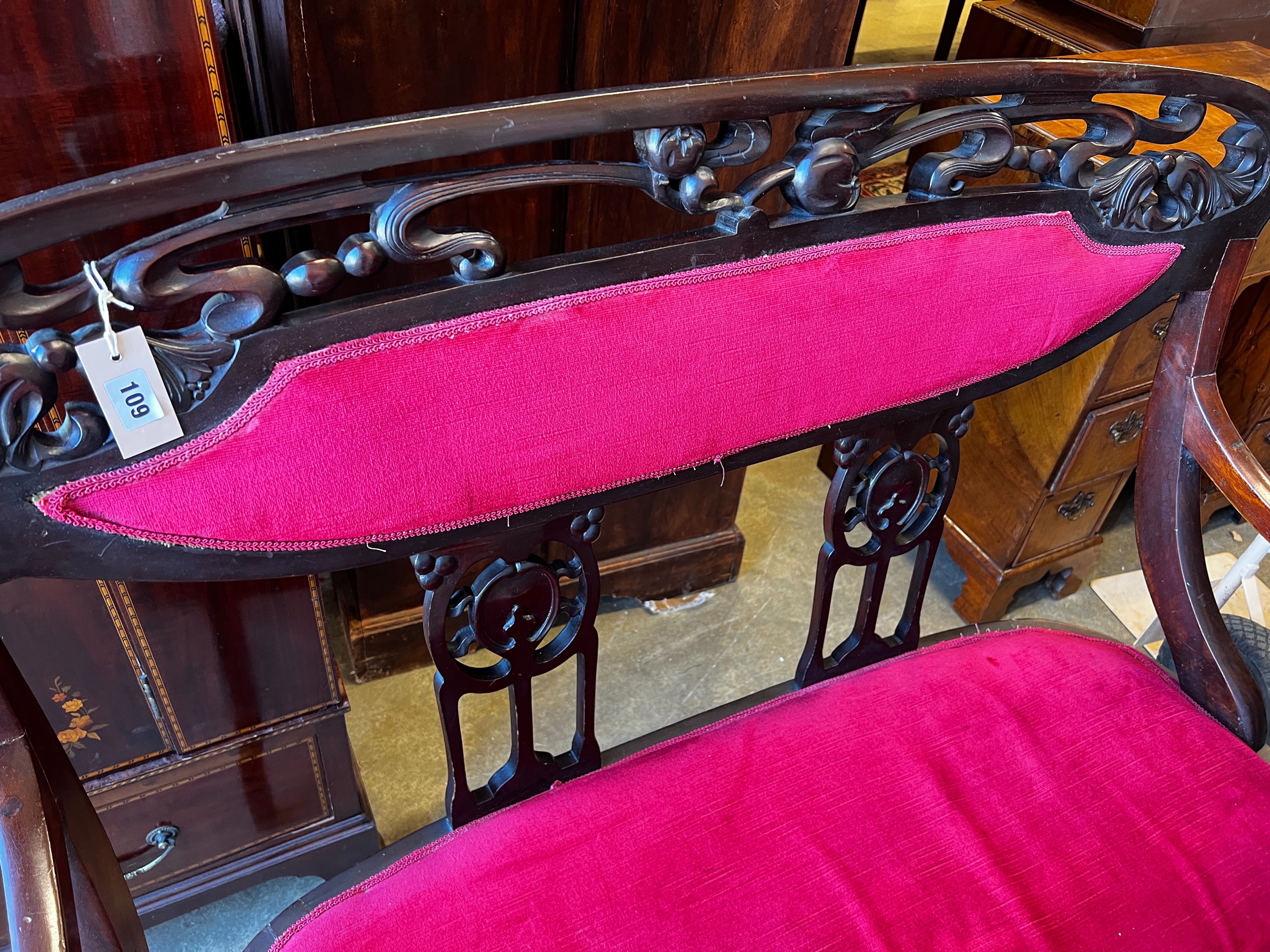 A late Victorian Art Nouveau mahogany upholstered salon settee, length 112cm, depth 50cm, height 106cm